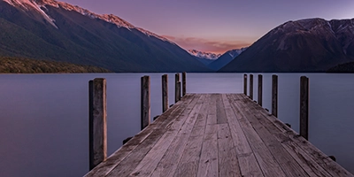 Sunset over the jetty at Lake Rotoiti, St Arnaud, long exposure creating a smooth water effect.