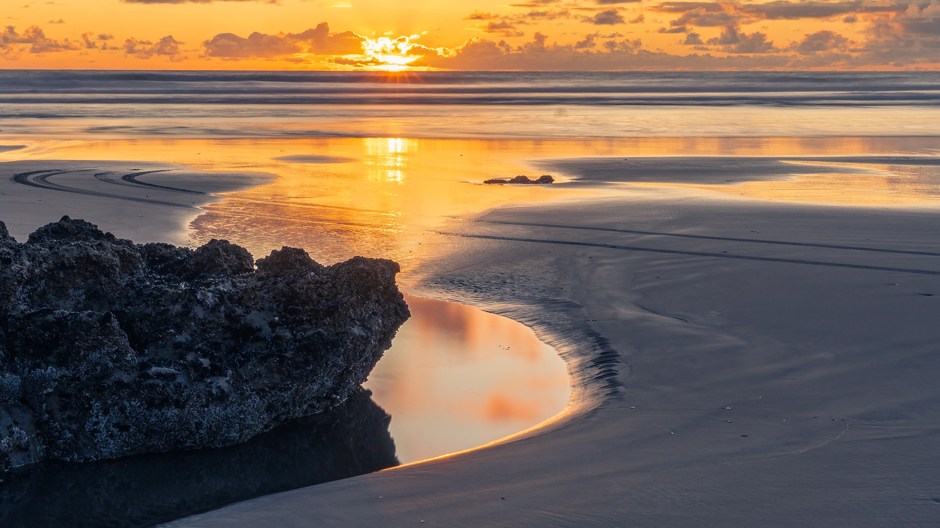 Sunset Beach Port of Waikato – Low Sun with Orange Light Trail Across Sea and Foreground Pool