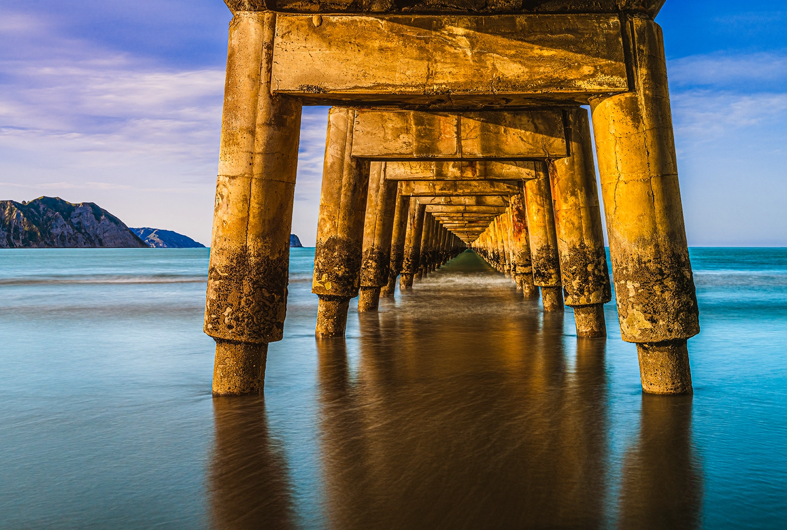 Under Tolaga Bay Wharf – Long Exposure of Historic Wharf Pilings at Golden Hour